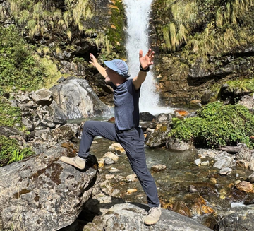 Freet founder Andrew Goss in rugged landscape with waterfall backdrop wearing Freet barefoot shoes