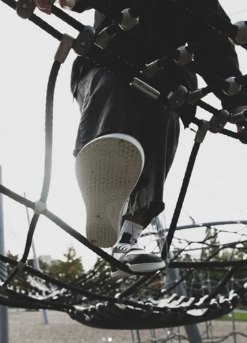 Realfoot's super wide fit worn by figure on a rope climbing frame