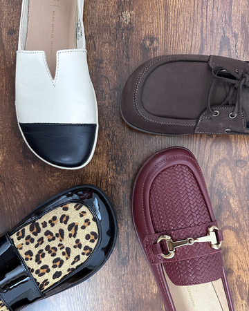 Barefoot Loafers from Happy Little Soles arranged on a wooden floor