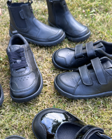 An arrangement of Happy Little Soles school shoes in an outdoor setting