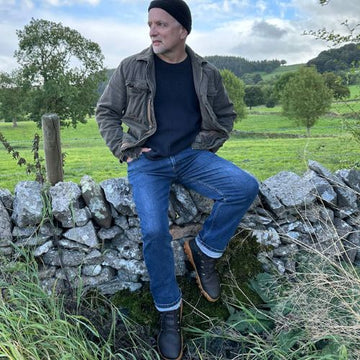 Coach and Trainer Jonny Drury sat on a stone wall.