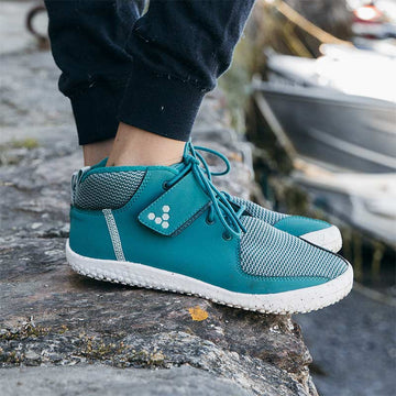 Person wearing Vivobarefoot shoes.