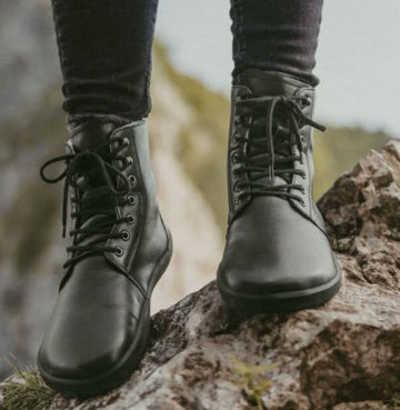 Woman wearing barefoot boots.