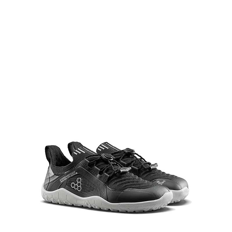 Pair of Vivobarefoot Kids Trainers Primus Trail Knit - Eclipse, angled view showing the outer side and front.