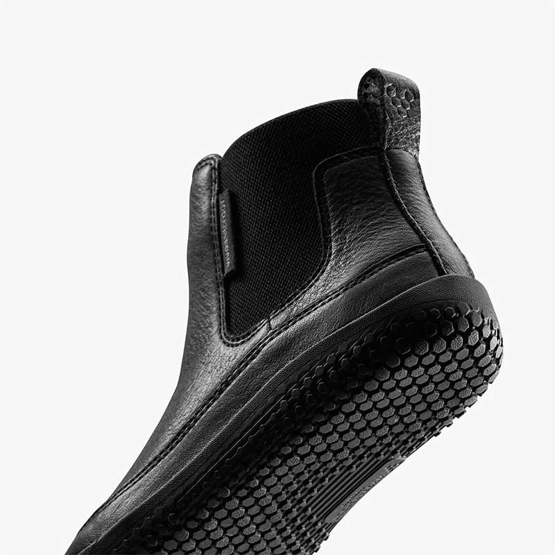 Vivobarefoot Kids Chelsea Boot Gobi - Obsidian, angled view showing the sole.
