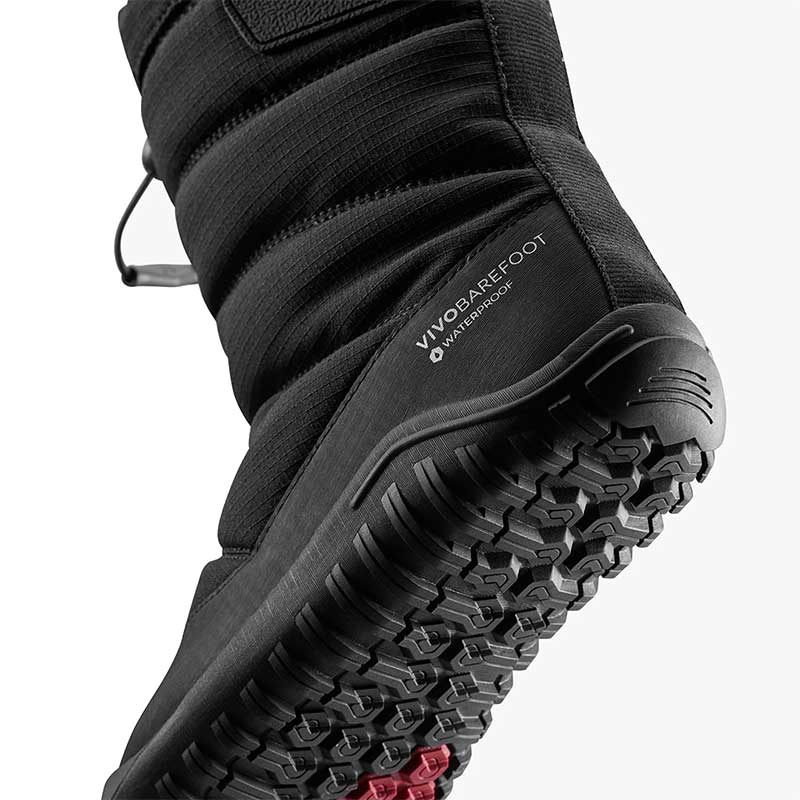 Vivobarefoot Kids Tracker Boot AT - Obsidian, angled view showing the sole.