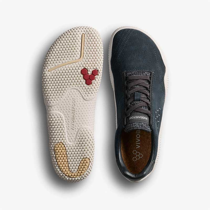Pair of Vivobarefoot Women's Motus Studio Trainers - Obsidian and White, one showing the sole view and the other showing the top view.