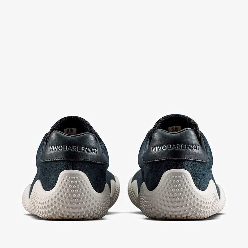 Pair of Vivobarefoot Women's Motus Studio Trainers - Obsidian and White, rear view.