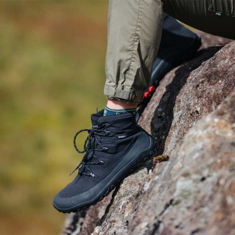 Person wearing Vivobarefoot Women's Hiking Boot Tracker Textile AT - Obsidian.