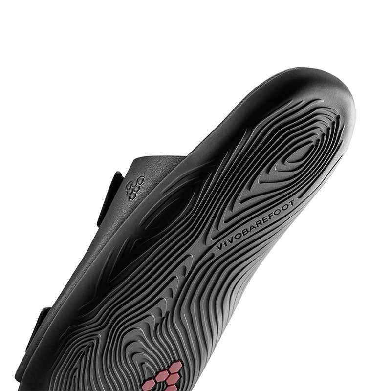 Vivobarefoot Women's Sandal Sensus Yin Slide - Obsidian, angled view showing the sole.