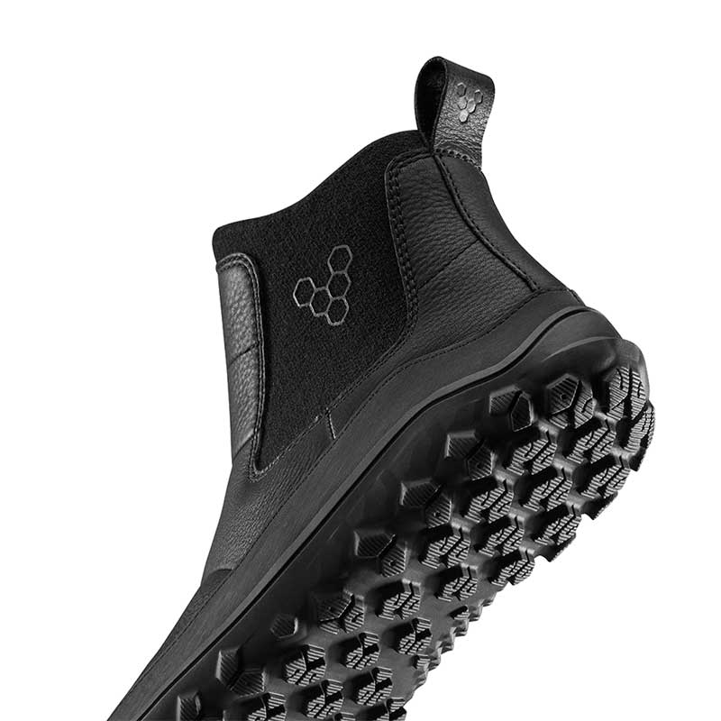 Vivobarefoot Women's Chelsea Boot Explorer - Obsidian, angled view showing the sole view.