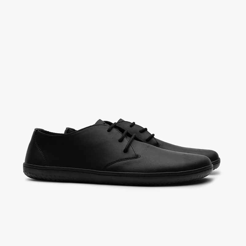 Pair of Vivobarefoot Men's Shoes Ra IV - Obsidian, angled view showing the outer side.