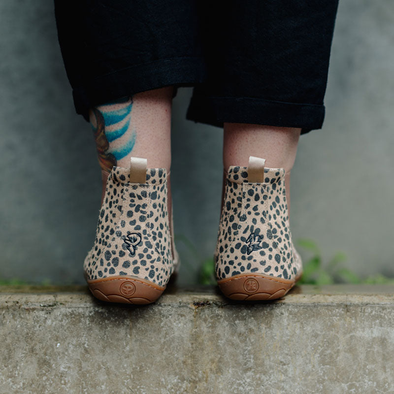 Person wearing PaperKrane Adults Chelsea Boots - Cheetah, rear view.