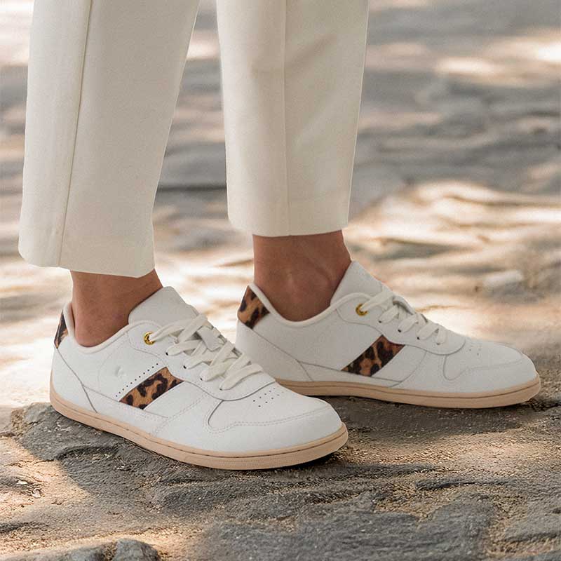 Persone wearing Be Lenka Adults Trainers Cellestia White and Leopard with cream trousers