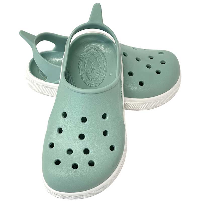 Pair of Boatilus Cloggy Sandals - Pastel Green White, one resting against the other, one showing the front view and the other slightly showing the outer side.