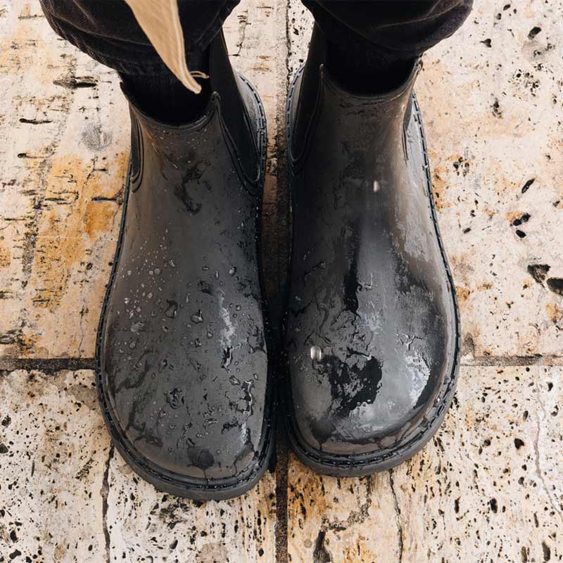 Person wearing Mukishoes Galocha Wellington Boots - Black, top view.