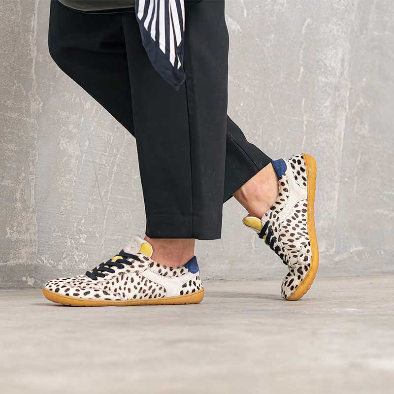 Person wearing Mukishoes Trainers Lyra - Cruella with black trousers.
