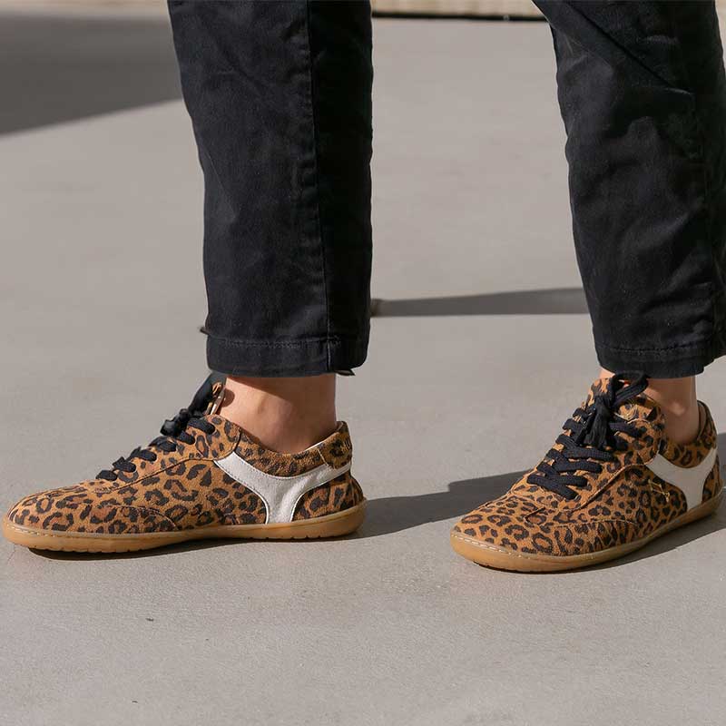 Person wearing Mukishoes Trainers Lyra - Leo with black trousers.
