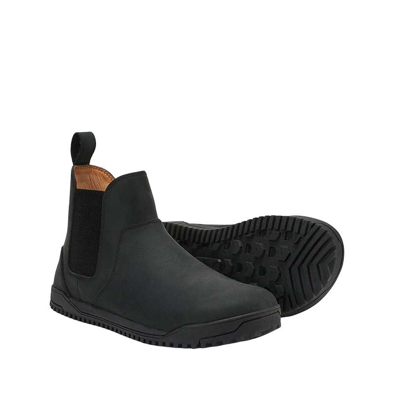 Pair of Xero Men's Chelsea Boots Ridgeway - Black, one on its side slightly showing the sole view and the other, angled showing the outer side and front.