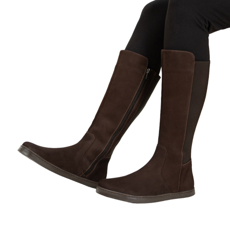 Person wearing Peerko Women's Regina II Boots - Brown (Narrower Calf), side view.
