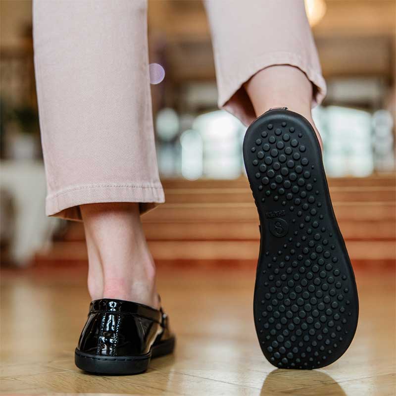 Person wearing Shapen Women's Sheen Loafers - Black Metallic.