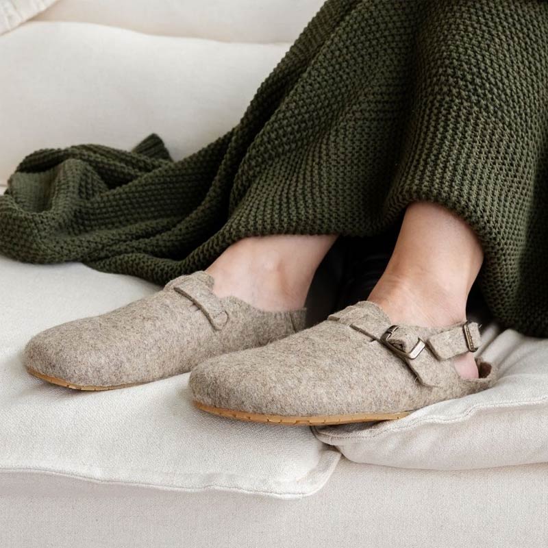 Person wearing Mukishoes Soca Lana Wool Slippers - Beige.