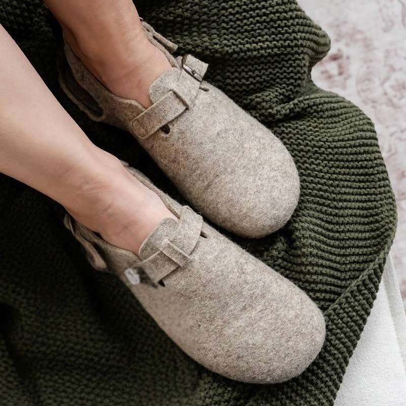 Person wearing Mukishoes Soca Lana Wool Slippers - Beige, top view.