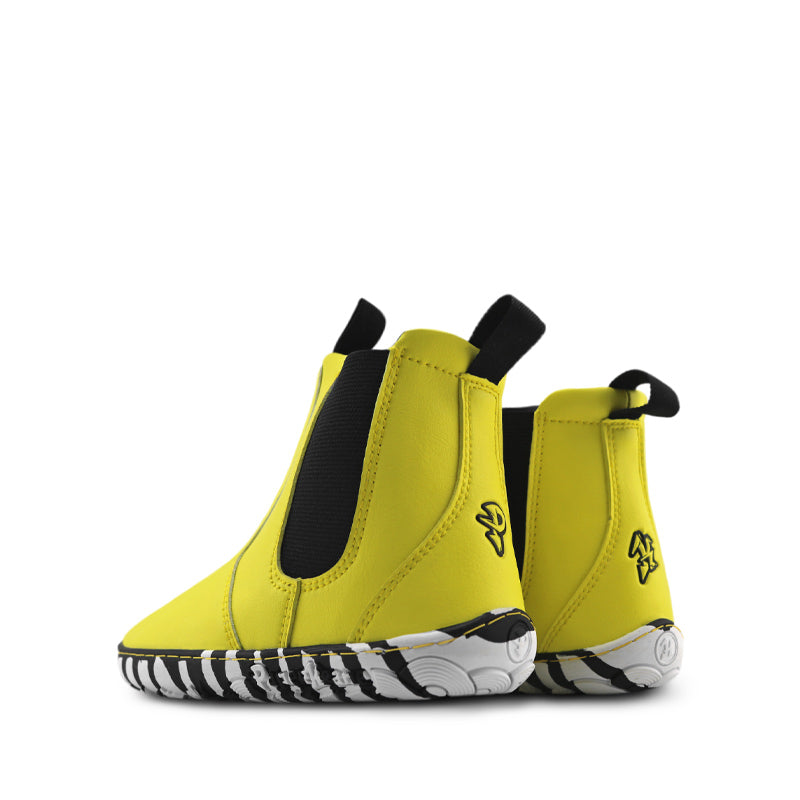 Pair of PaperKrane Kids Sunny Chelsea Boots - Yellow, angled view showing the outer side and rear.