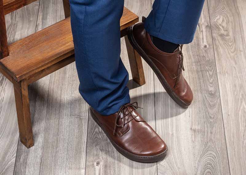 Person wearing Peerko Adults Shoes Smart - Business with blue trousers.
