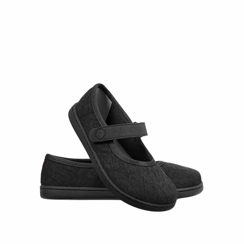 Pair of Be Lenka Kids Tinkee Ballet Shoes - All Black Sparkle, one leant against the other showing the outer side and front.