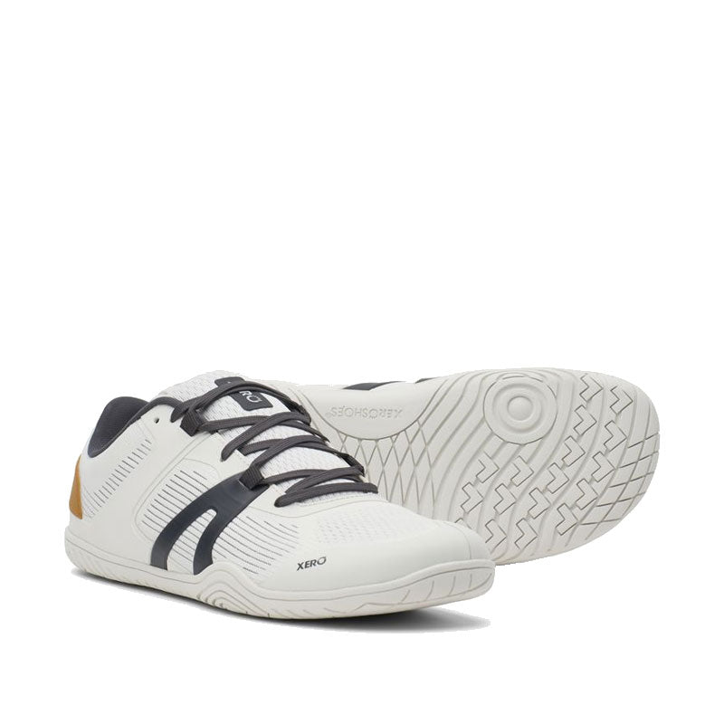 Pair of Xero Women's Trainers 360 Rally - White Asphalt, one angled showing the outer side and front view and the other showing the sole view.
