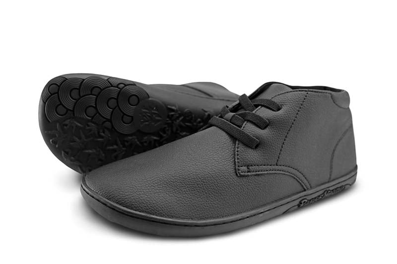 Pair of PaperKrane Kids Vegan Biro School Shoes in black, one angled showing outer side and front, the other on it's side showing the sole.
