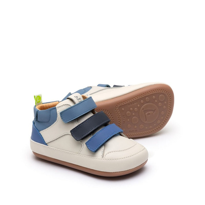 Pair of Tip Toey Joey Toddler Boots Metropoly - Tapioca/Blue Tang/Navy, one showing the outer side and the other showing the sole.