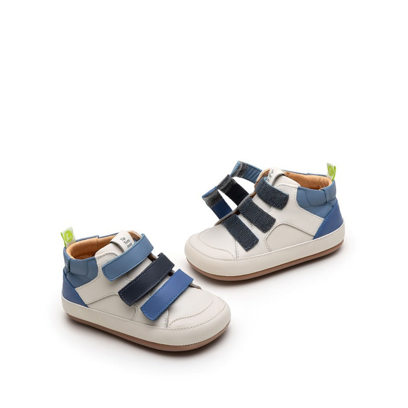 Pair of Tip Toey Joey Toddler Boots Metropoly - Tapioca/Blue Tang/Navy, one showing the outer side view with straps fastened and the other showing the outer side with straps open.