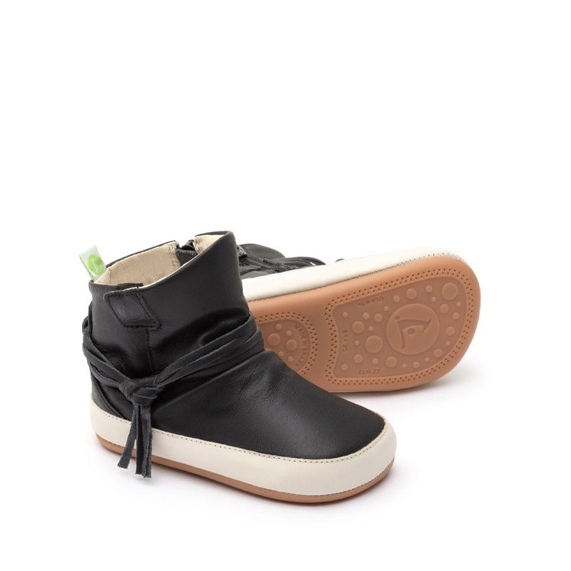 Pair of Tip Toey Joey Toddler Boots Ridgely - Black and Tapioca, one showing the outer side and the other showing the sole.