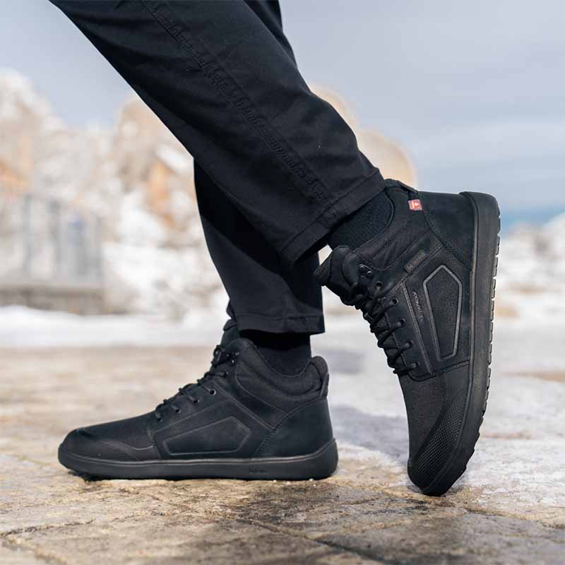 Person wearing Be Lenka Adults Boots Arctic Edge - All Black with black jeans