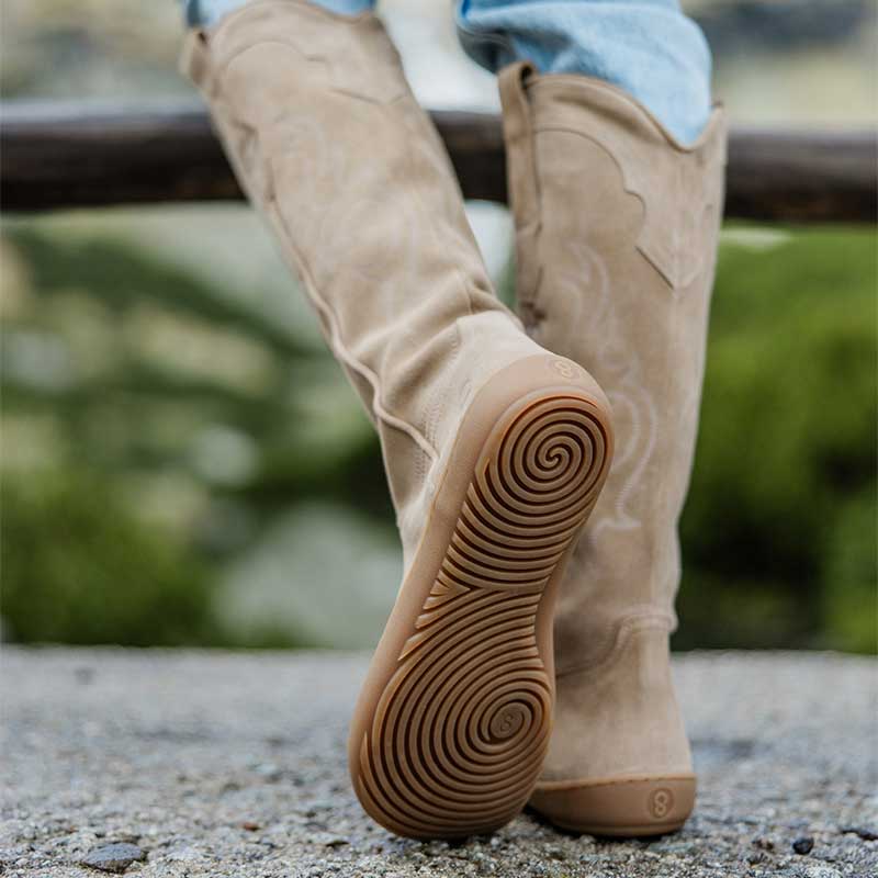 Person wearing Shapen Women's Arizona Cowboy Boots - Beige with jeans, rear and sole view.