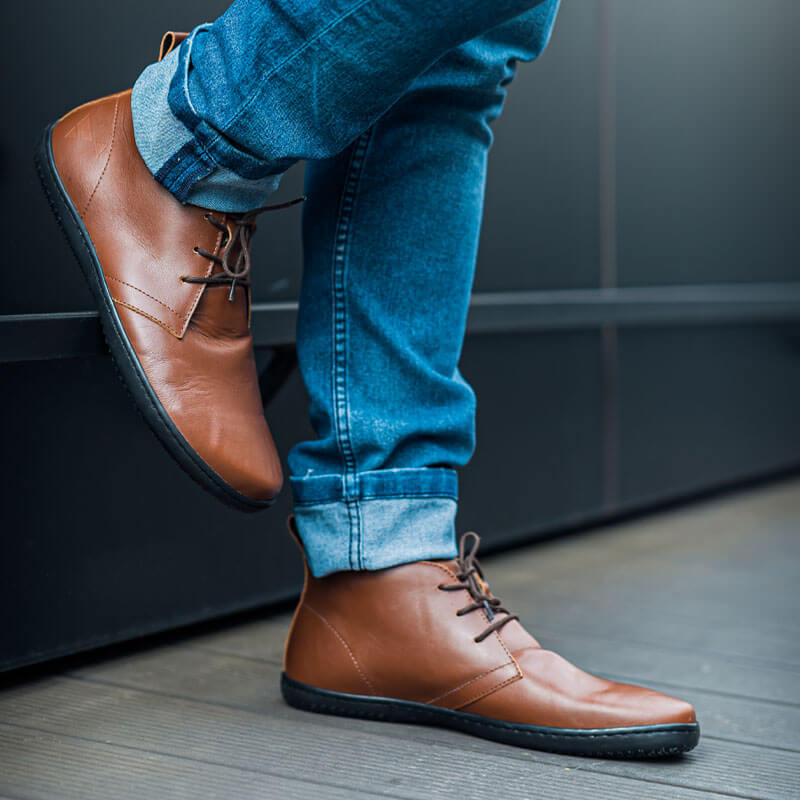 Person wearing Angles Adults Boots Atlas - Black with blue jeans