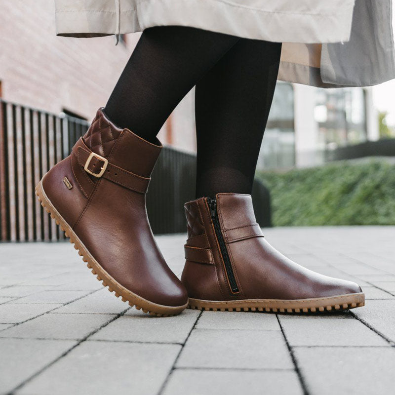Person wearing Be Lenka Adults Boots Diva - Brown with black tights