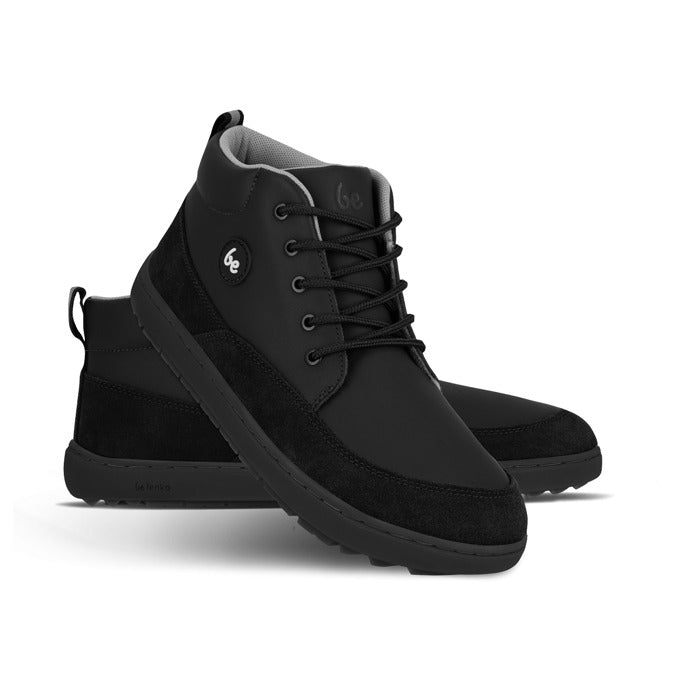 Pair of Be Lenka Junior Boots Elio - Black, one angled and leaning showing the outer side, the other partially showing the inner side