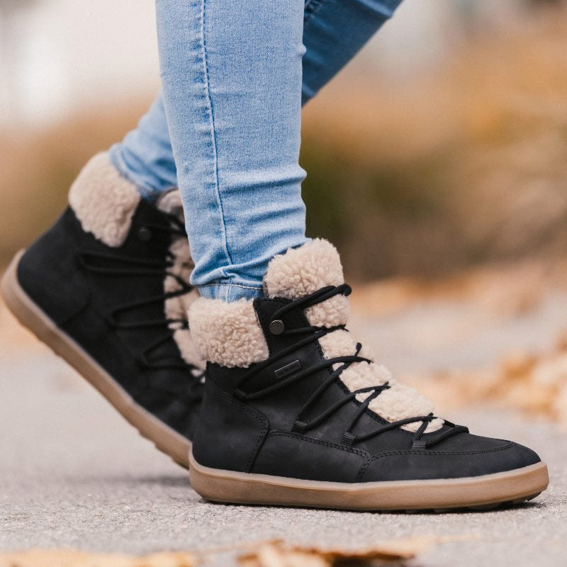 Person wearing Be Lenka Adults Boots Bliss - Black with blue jeans