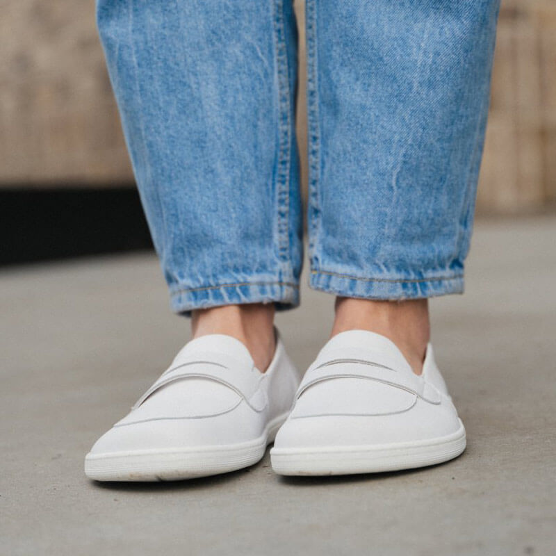 Person wearing Be Lenka Women's Moccasins Buena - White with light denim jeans, front view