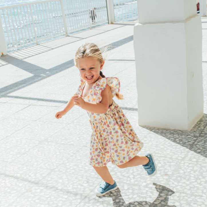 Child wearing Igor Canvas V Shoes - Jeans with floral dress.