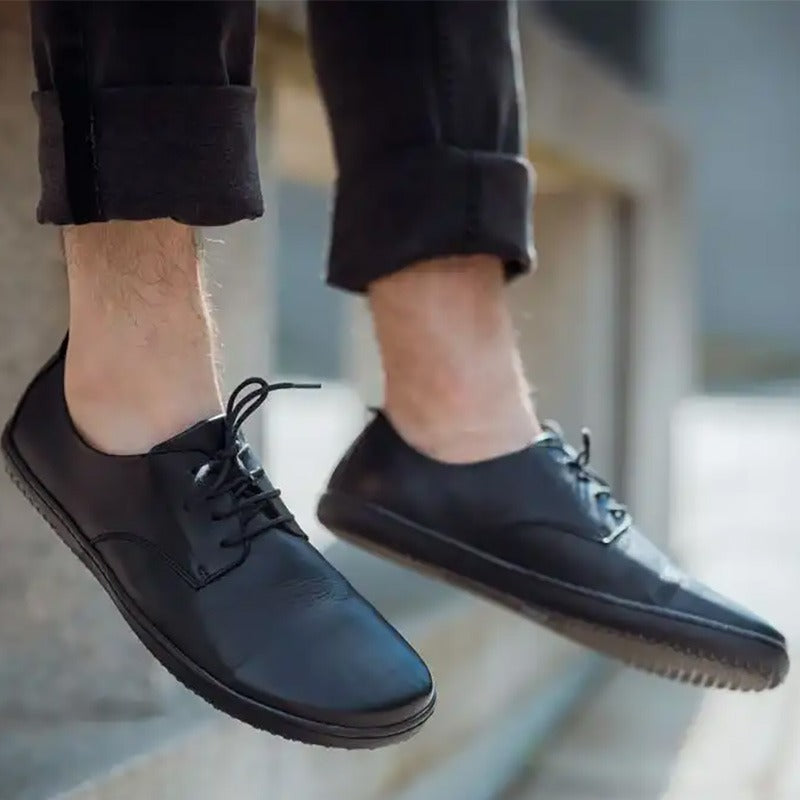 Person wearing Angles Adults Shoes Chronos - Black with black trousers