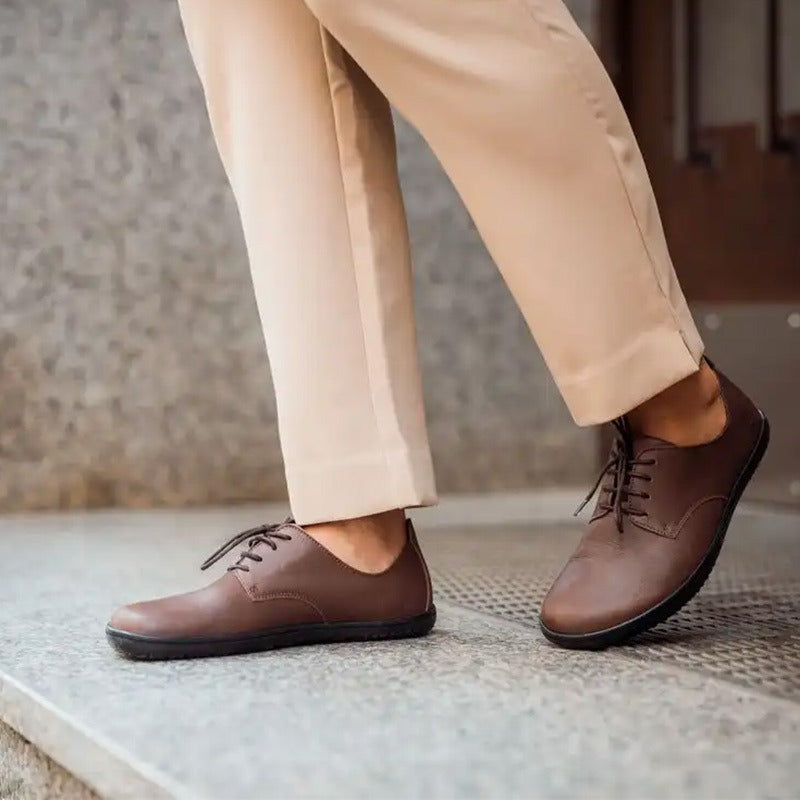 Person wearing Angles Adults Shoes Chronos - Nut with beige trousers