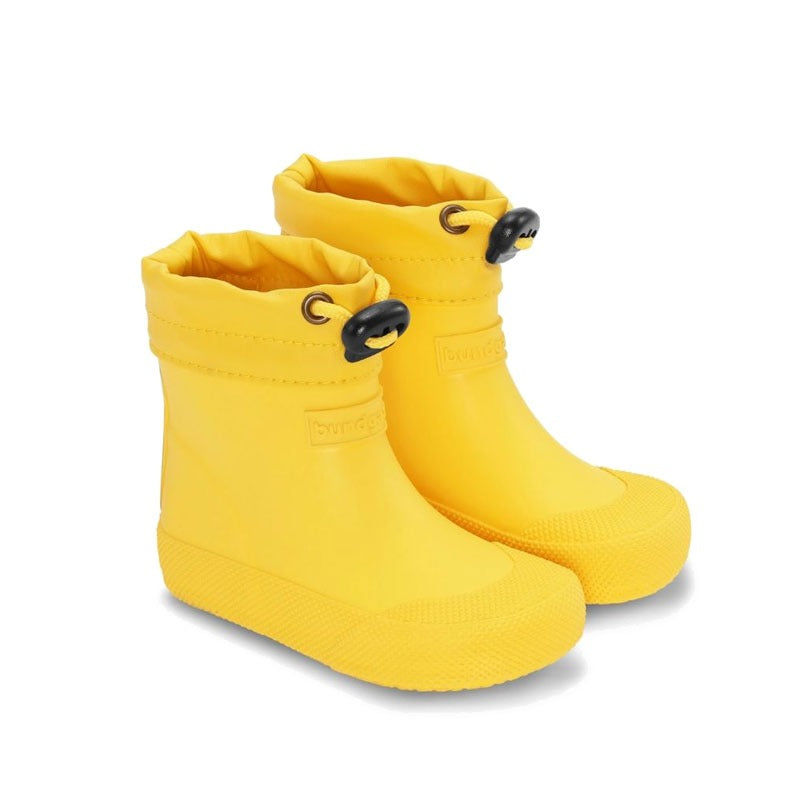 Pair of Bundgaard Toddler Wellies Cover - Sunflower, angled view showing outer side and front.
