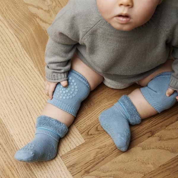Boy wearing Go Baby Go Crawling Kneepads in dusty blue, view from above.