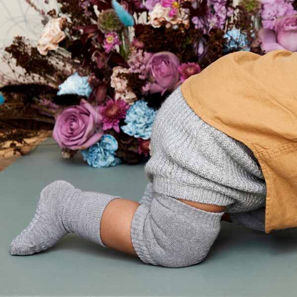 Close up of child wearing Go Baby Go Crawling Kneepads in grey.