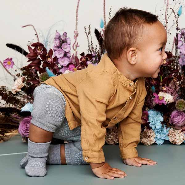 Child wearing Go Baby Go Crawling Kneepads in grey.