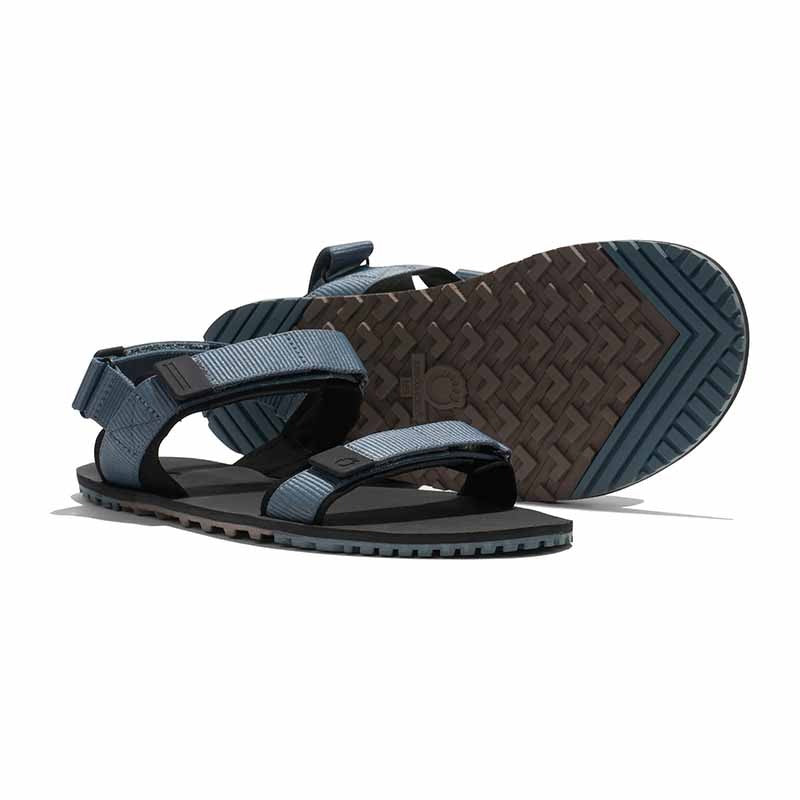 Pair of Xero Men's Sandals D-Trail - Stormy Weather Black, one showing the outer side and the other showing the sole.